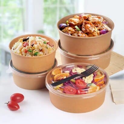 Premium brown round kraft paper salad bowls with transparent clear lids filled with fresh salad and rice