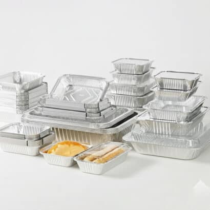 Stack of premium silver aluminium foil takeaway containers and baking pans in various shapes and sizes